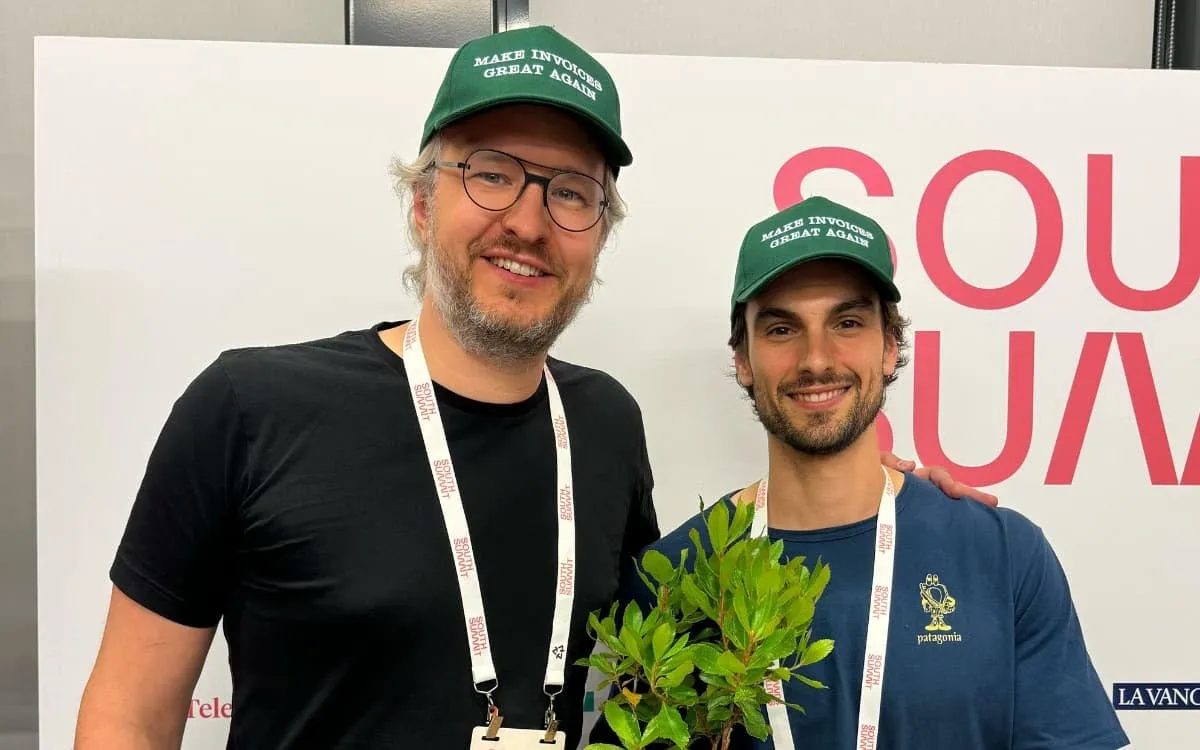 Invopop co-founders Sam Lown and Juan Moliner at South Summit Madrid 2024, in matching caps