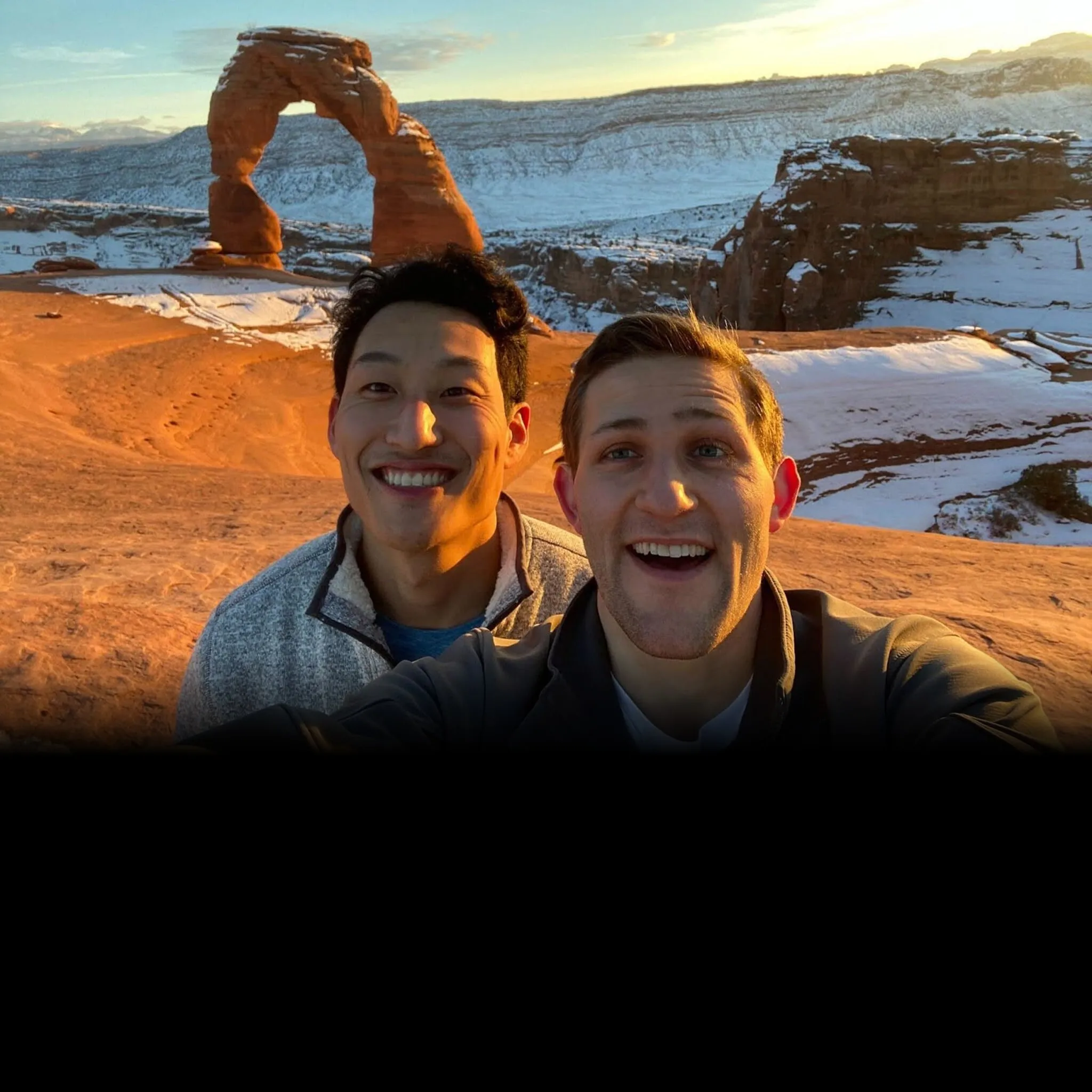 Double co-founders Kenny Song and Ben Stein taking a selfie in front of a red rock arch in the snow