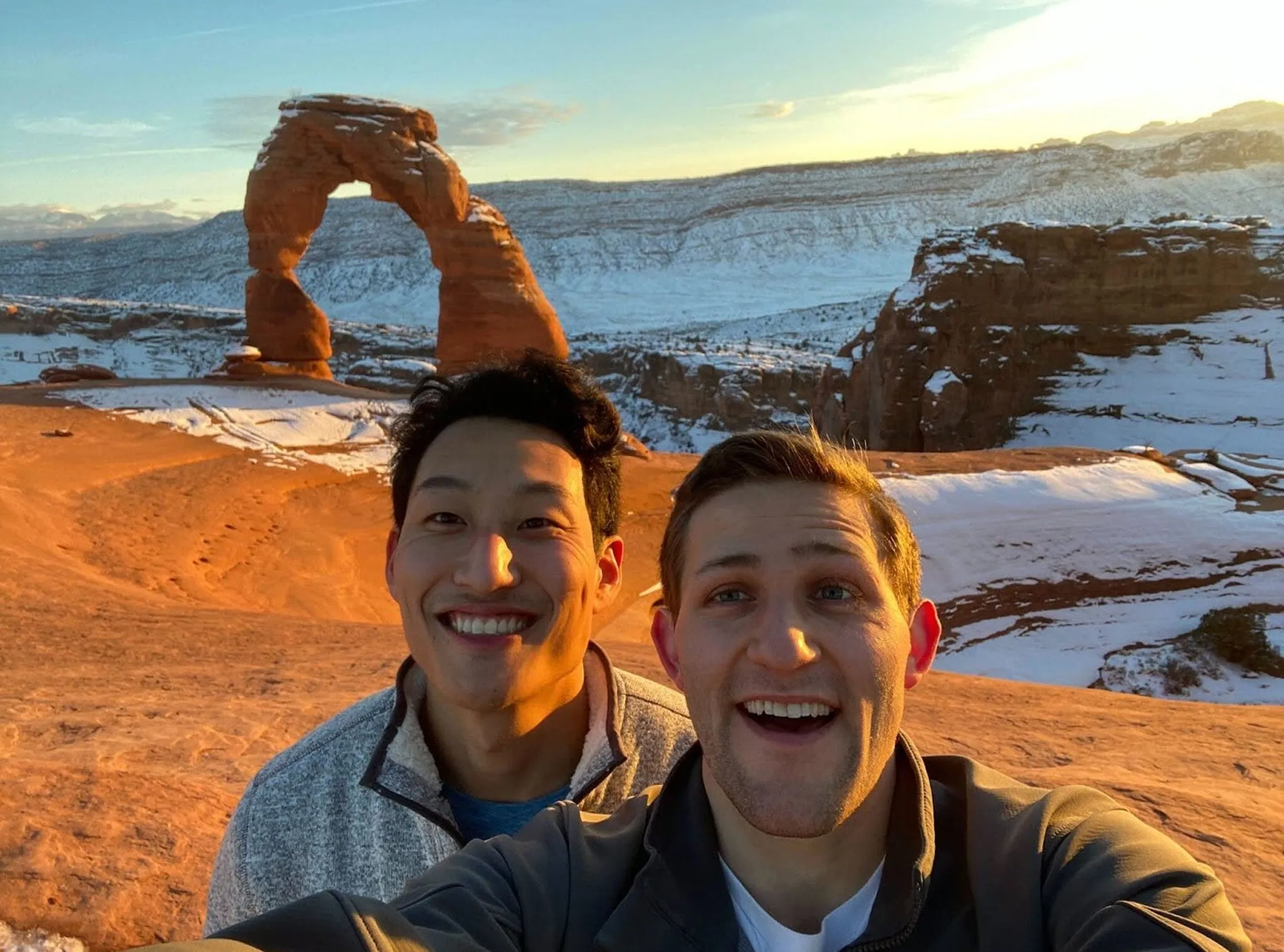 Double co-founders Kenny Song and Ben Stein taking a selfie in front of a red rock arch in the snow