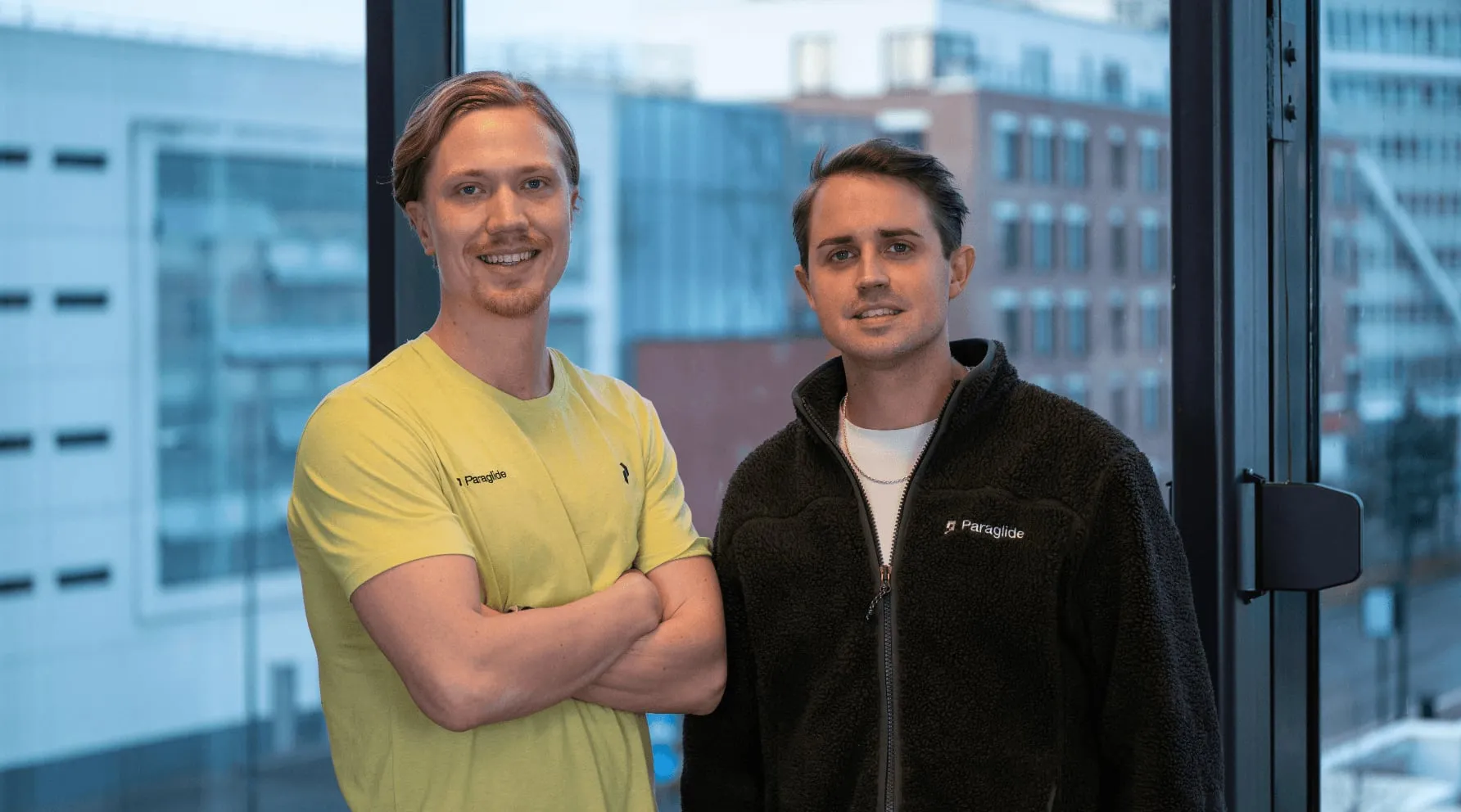 Paraglide co-founders Rasmus Areskoug and Andreas Åström by an office window