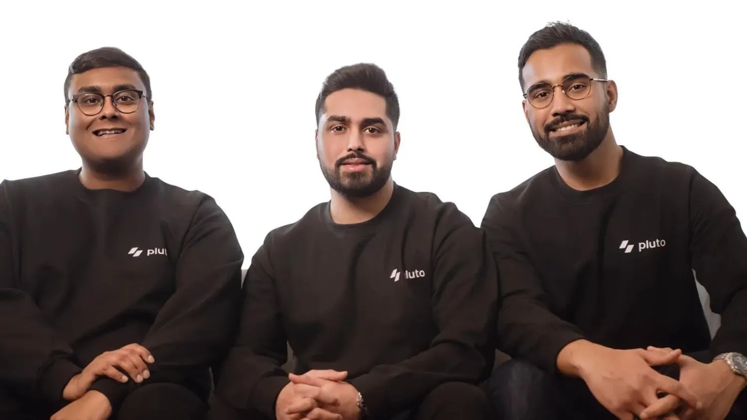 Pluto’s co-founders Nayeem Zen, Mo Aziz and Mohammed Ridwan in black Pluto sweatshirts
