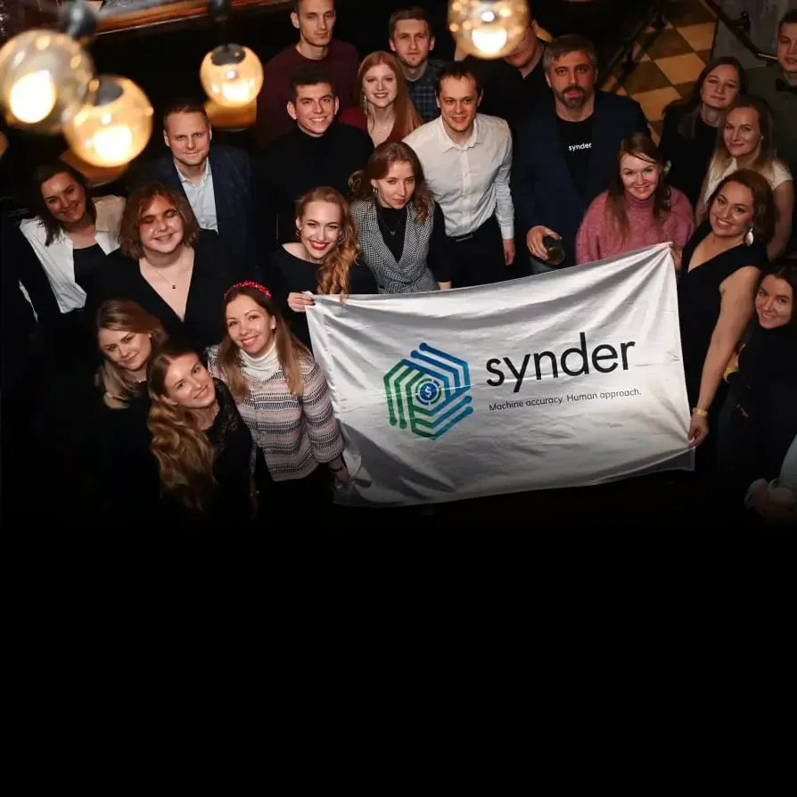 The Synder team holding a banner with the Synder logo